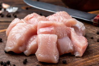Diced chicken fillets on butchers block
