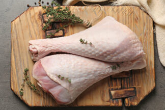 Two turkey legs on chopping board